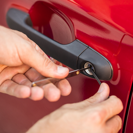 Locksmith unlocking red car door